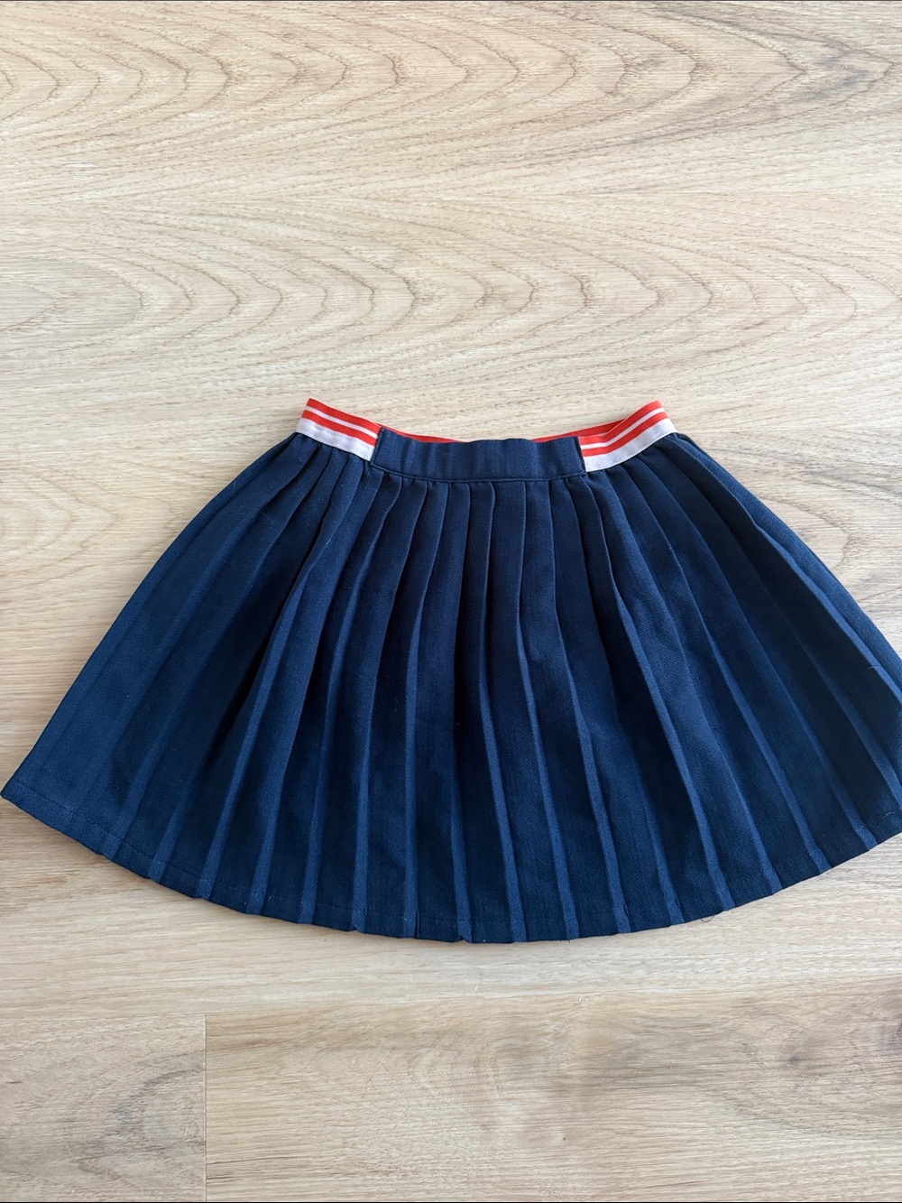 Girls Navy Pleated Skirt with Red-Trim Waistband